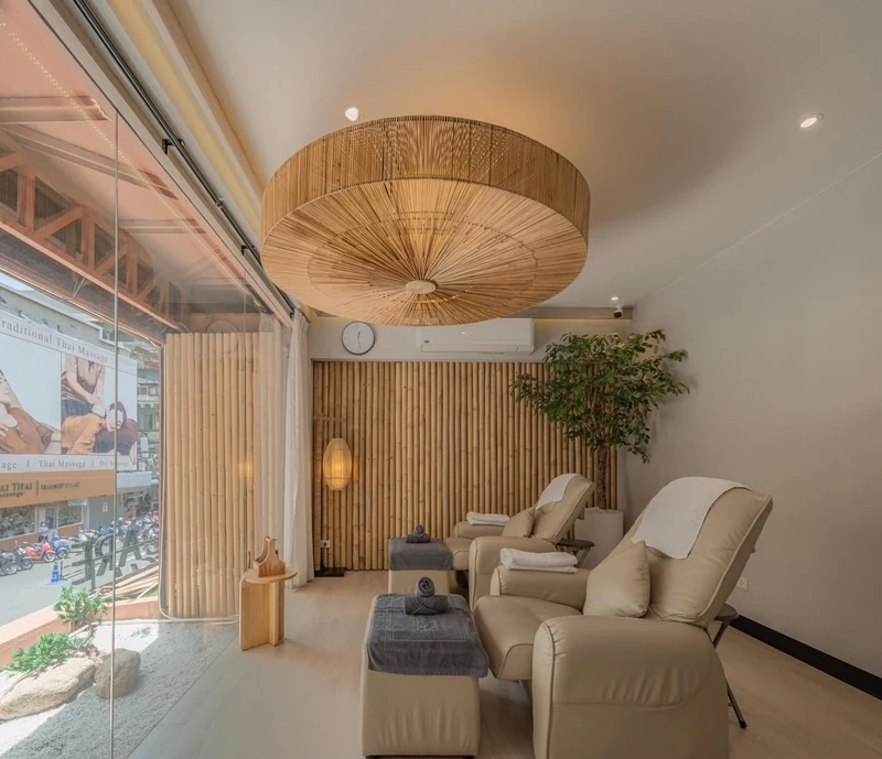 Foot-massage lounge with reclining chairs facing the street window at Pela Thai Massage on Siam Square Soi 6, a massage in Siam Bangkok